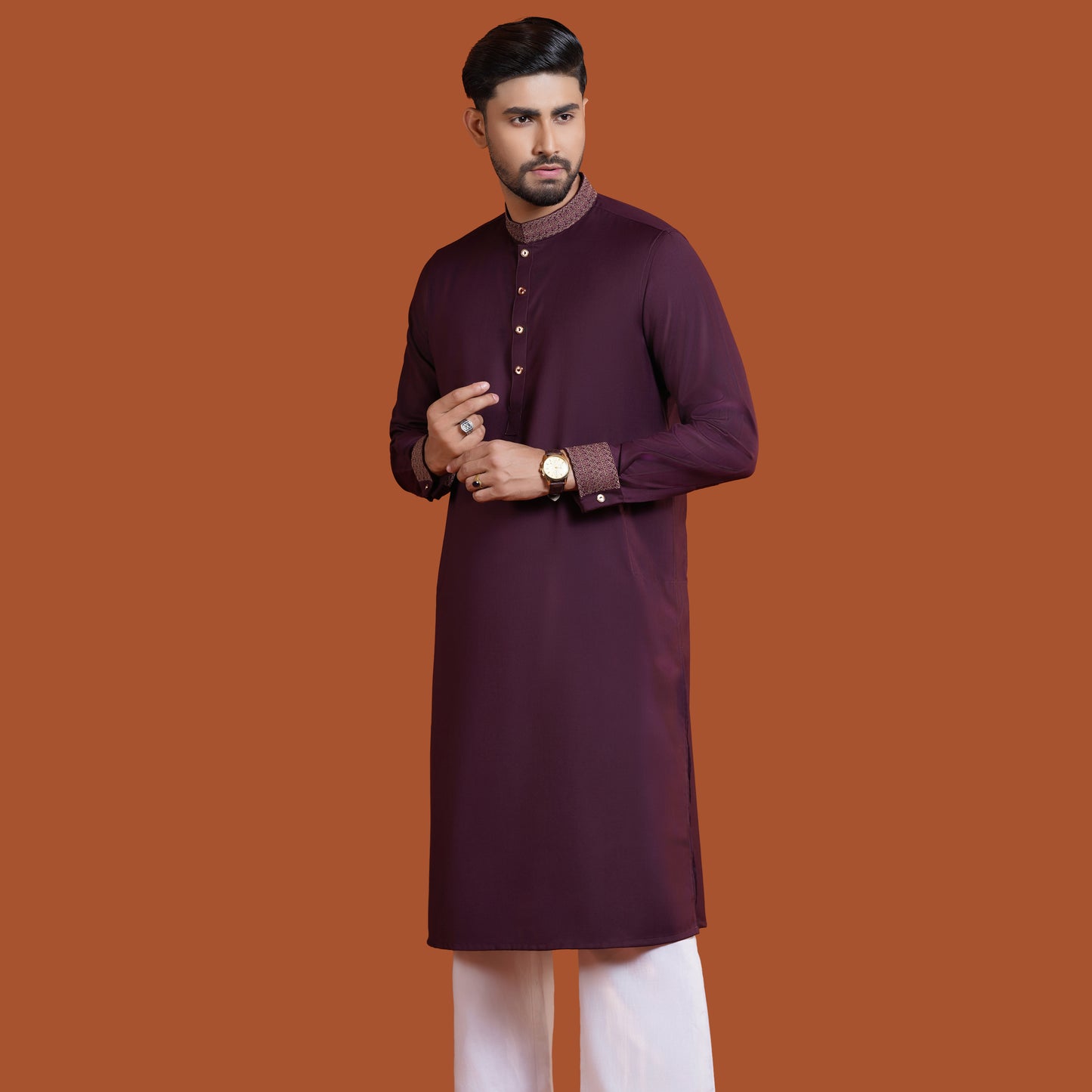 Man wearing a maroon YAMAAN kurta with a brown background