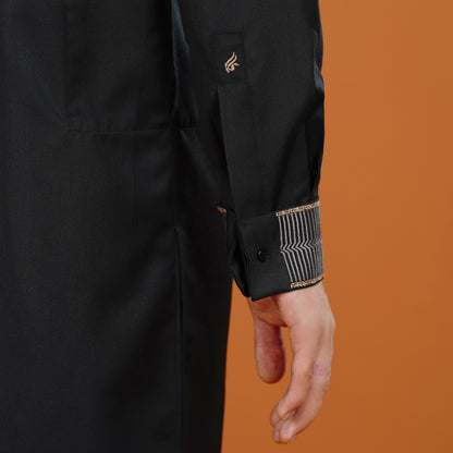 Black coat with gold accents on an orange background