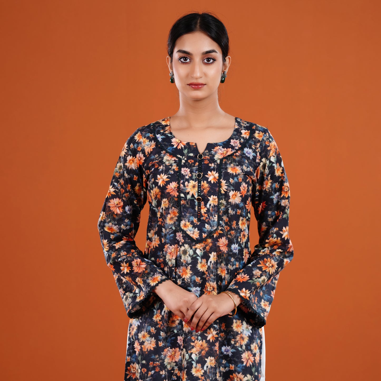 Woman wearing a floral dress against an orange background