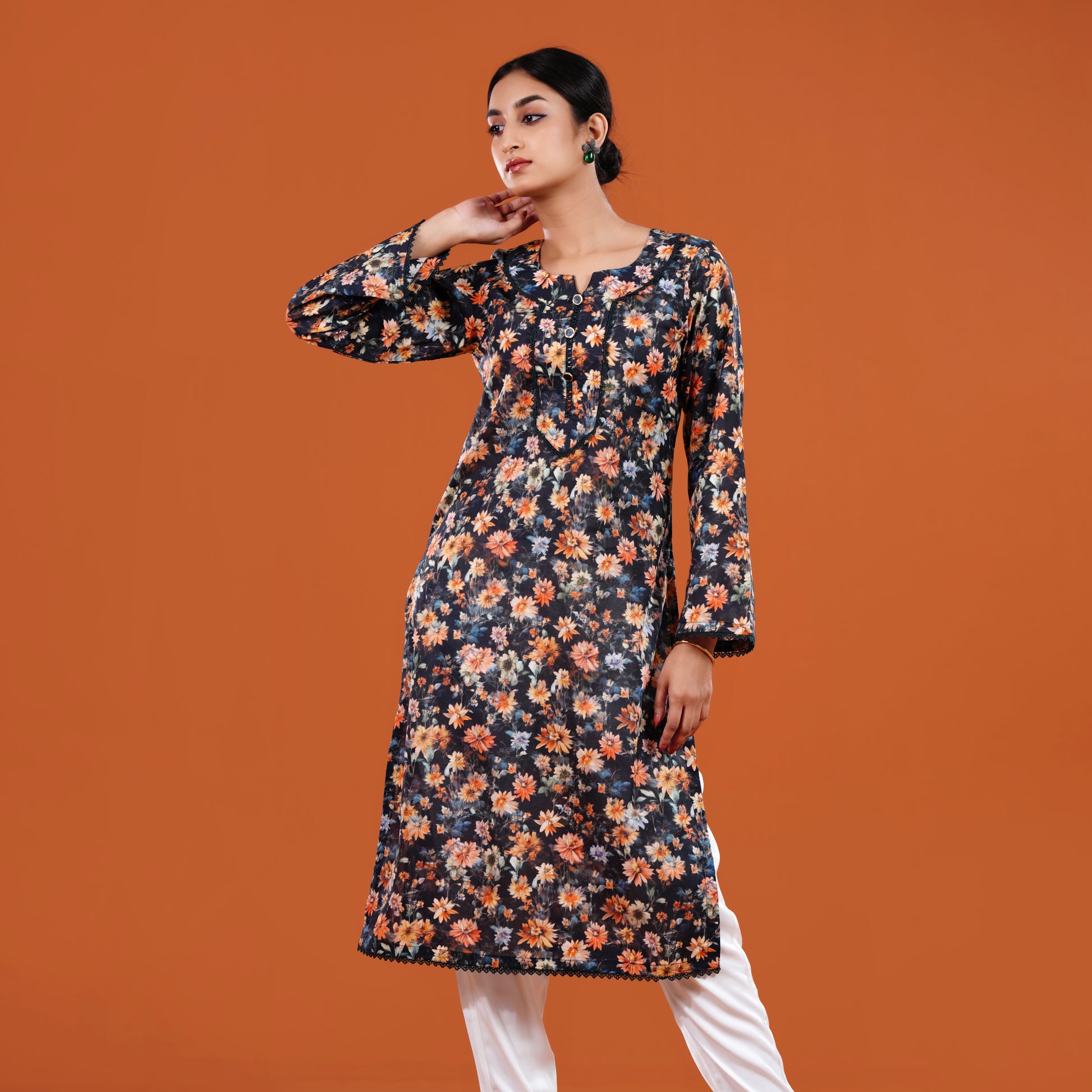 Woman wearing a floral dress against an orange background