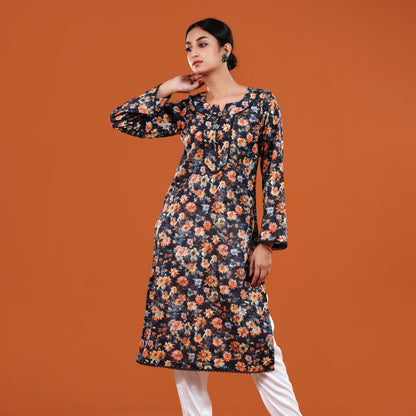 Woman wearing a floral dress against an orange background