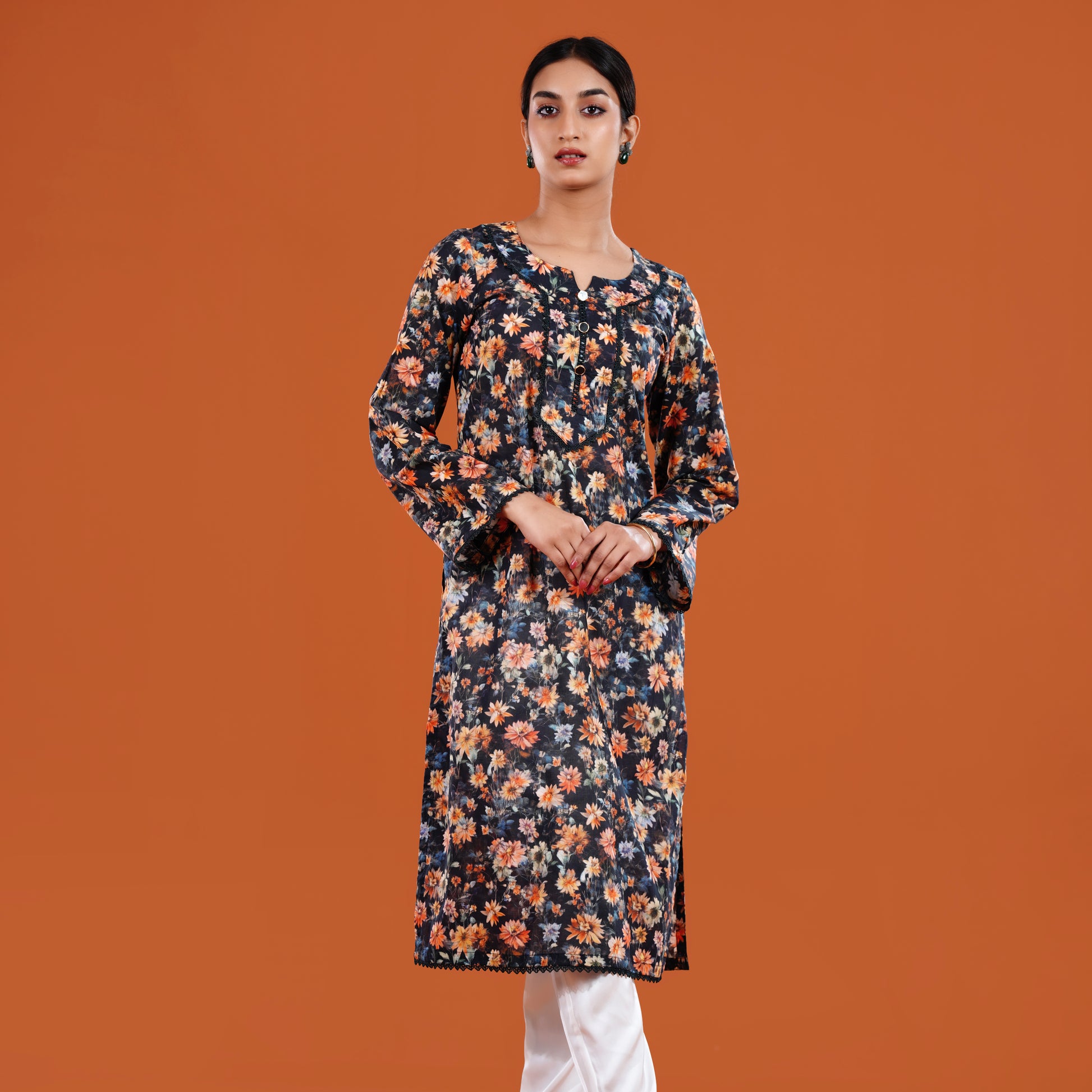 Woman wearing a floral dress against an orange background