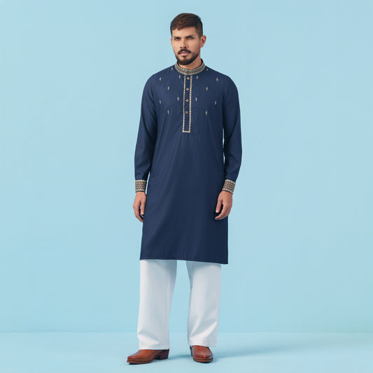 Man wearing a navy blue embroidered YAMAAN kurta with white pants on a light blue background