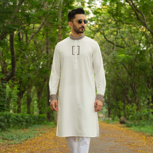 YAMAAN Man wearing a white kurta with patterns in a forest setting