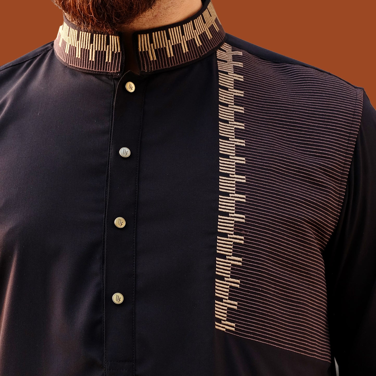Black panjabi with decorative collar and chest panel on a brown background