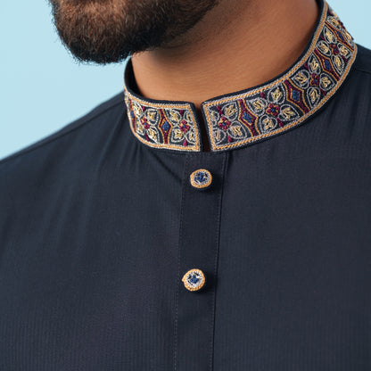 YAMAAN Navy blue panjabi with embroidered collar against a light blue background
