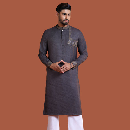 Man wearing a dark olive YAMAAN
 kurta with white pants on a brown background
