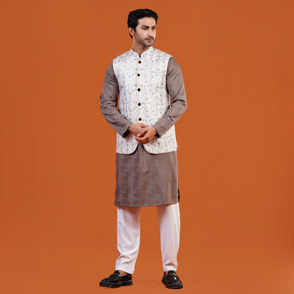 Man wearing a traditional YAMAAN PANJABI with a YAMAAN WAISTCOAT on an orange background
