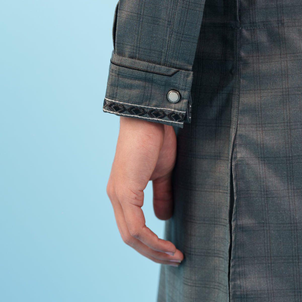 Hand peeking out from a gray suit jacket against a blue background