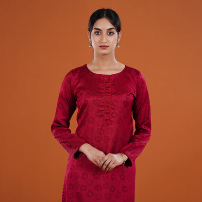 Woman wearing a red traditional outfit against an orange background