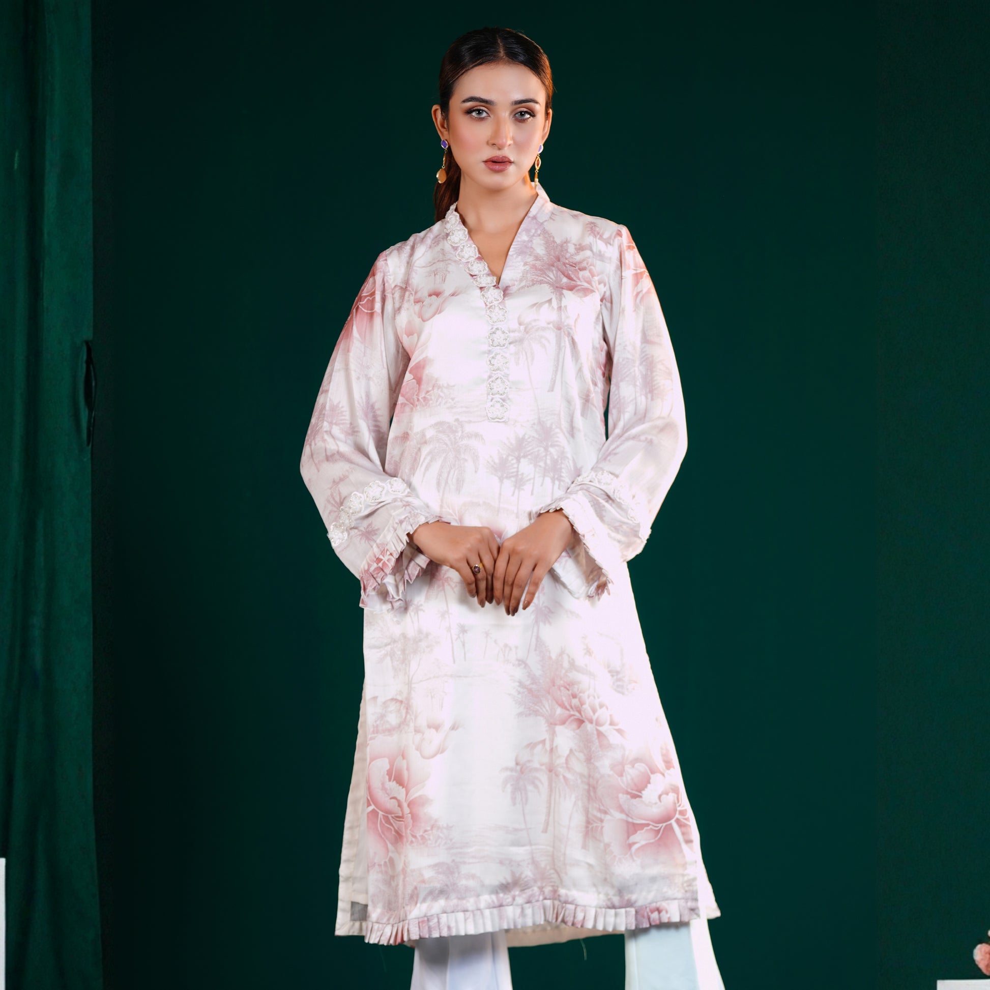 Woman wearing a YAMAAN Off White kurti Set light pink floral kurta against a dark green background