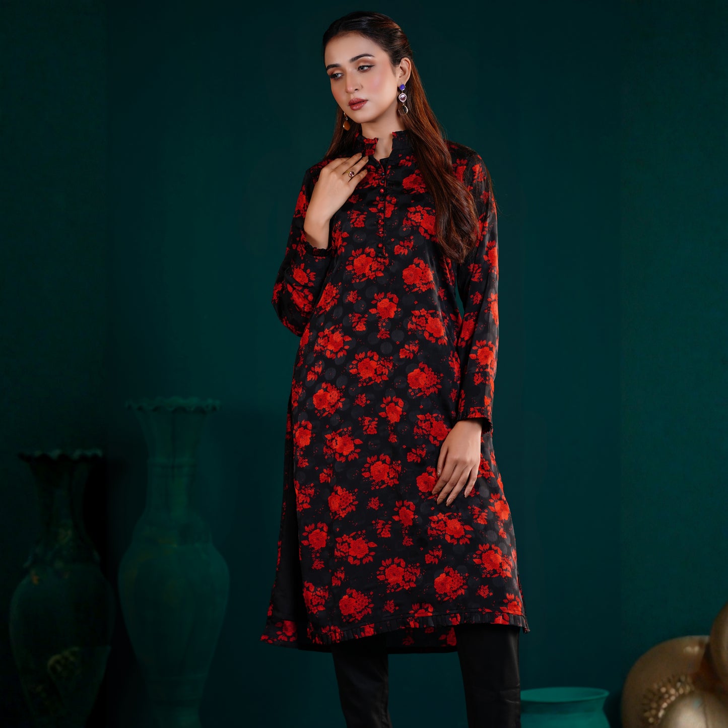 Woman wearing a YAMAAN Royal Red Kurti with red floral pattern against a dark green background