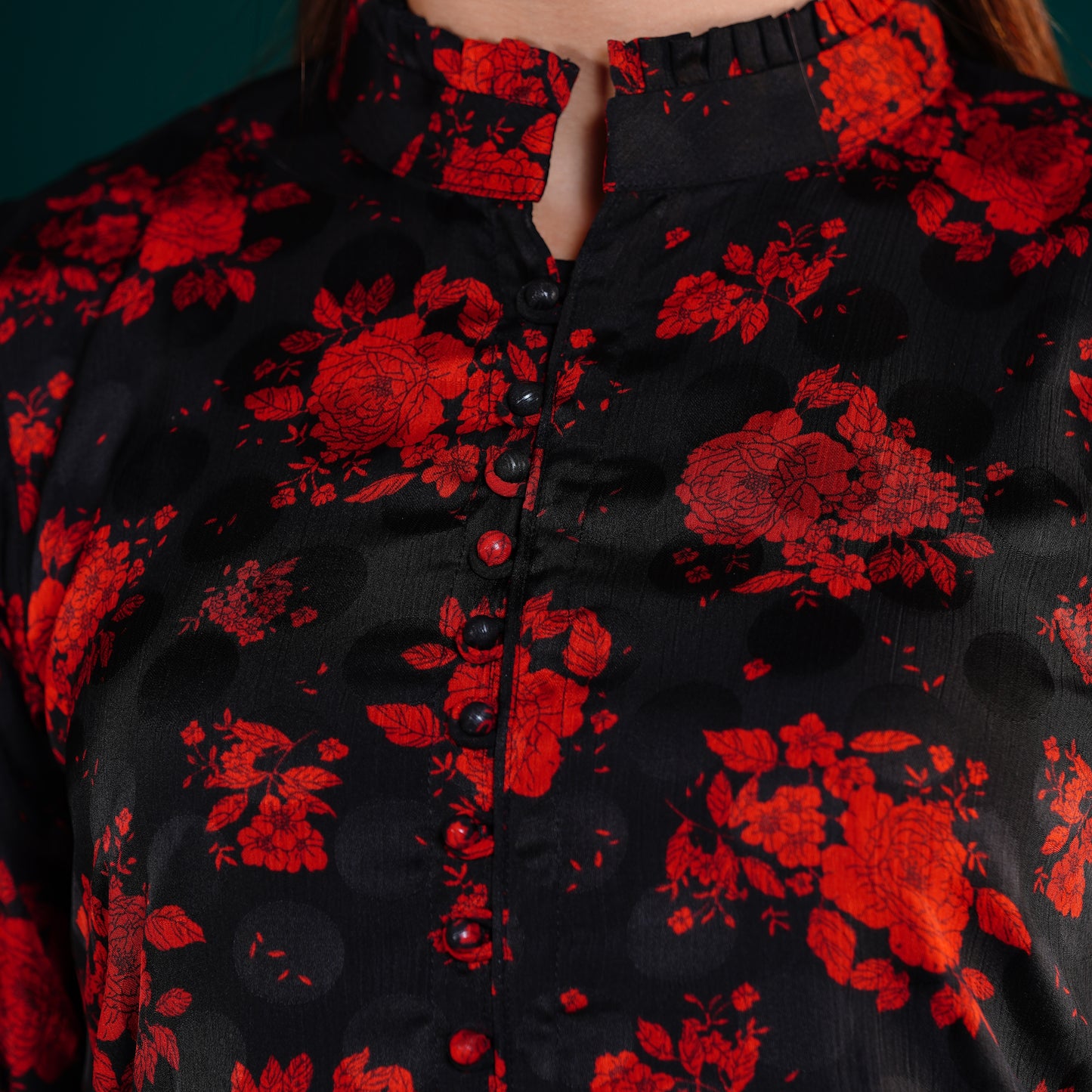 Close-up of a yamaan royal kurti with red floral patterns and buttons.