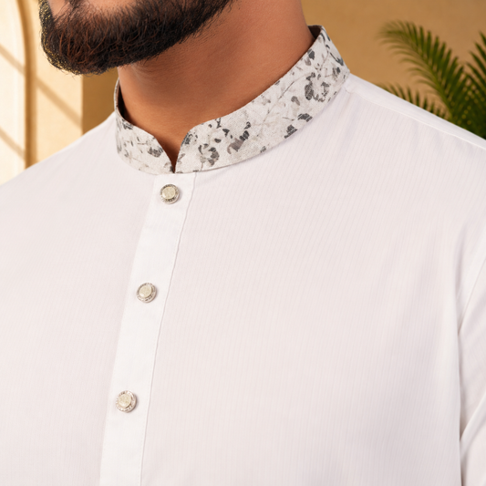 Close-up of a yamaan royal panjabi with a patterned collar against a neutral background