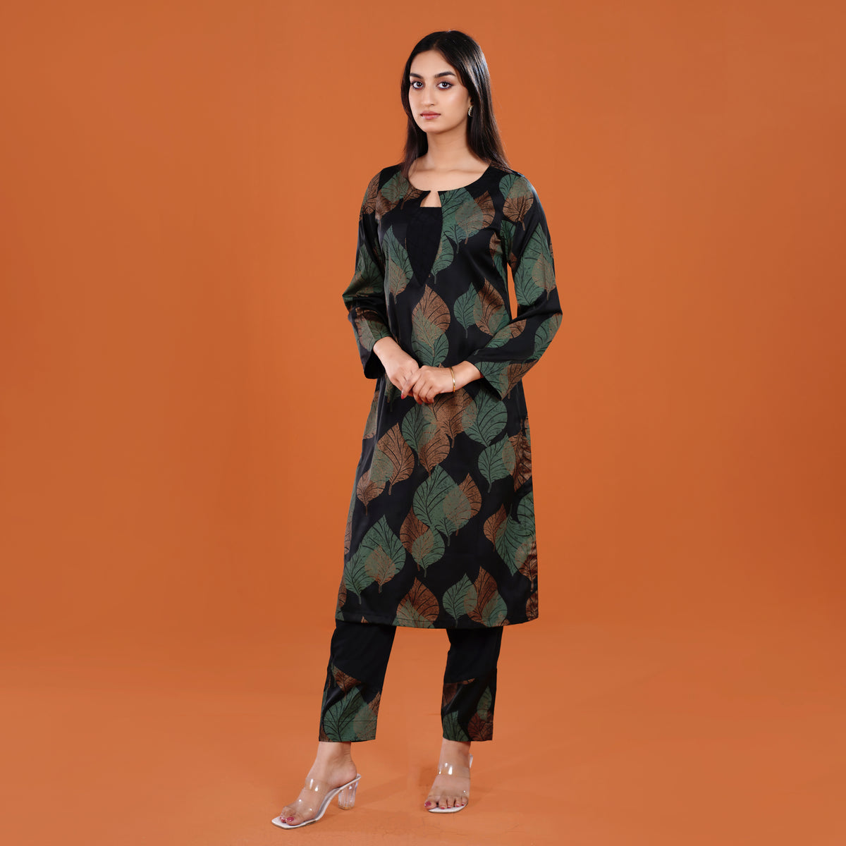 Woman wearing a patterned outfit on an orange background