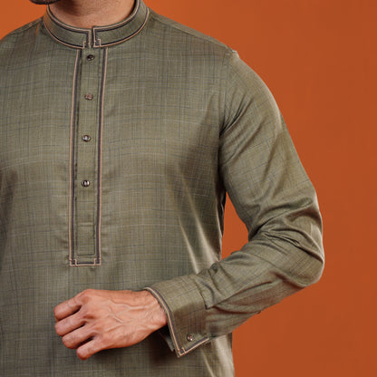 Yamaan traditional panjabi with brown trim on an orange background