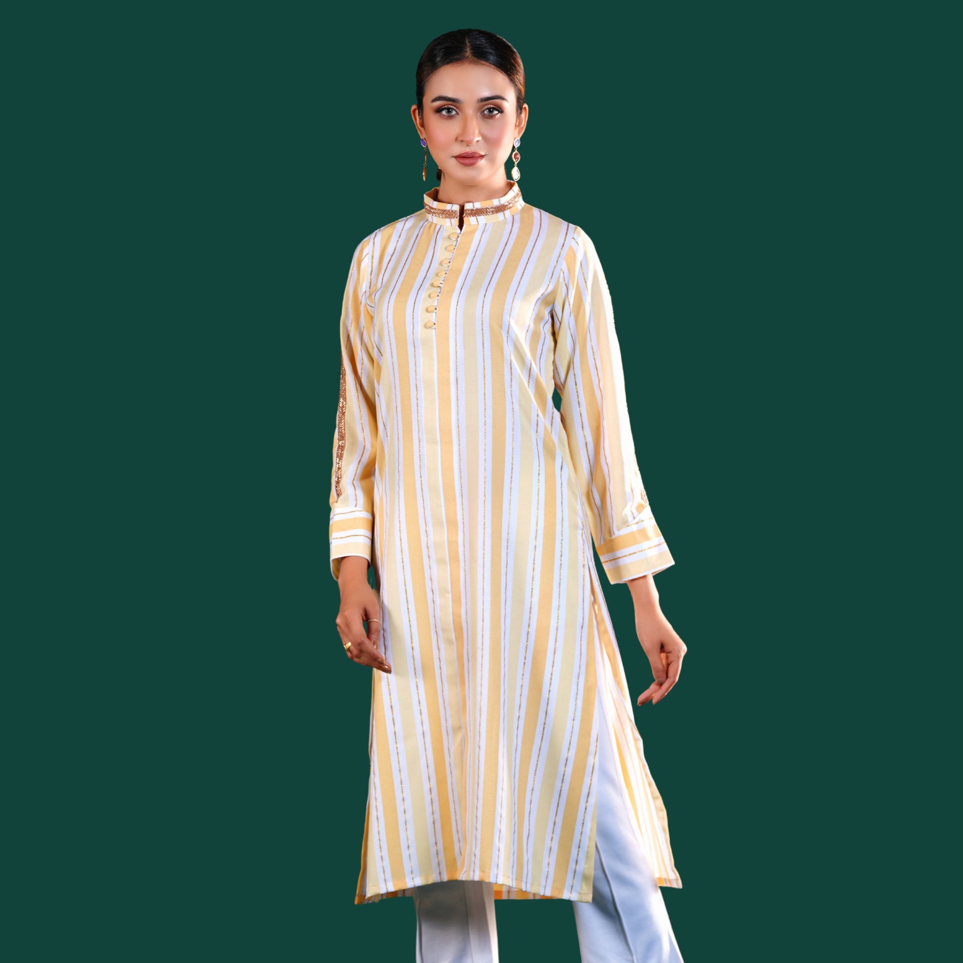 Woman wearing a yellow and white yamaan striped kurta against a green background