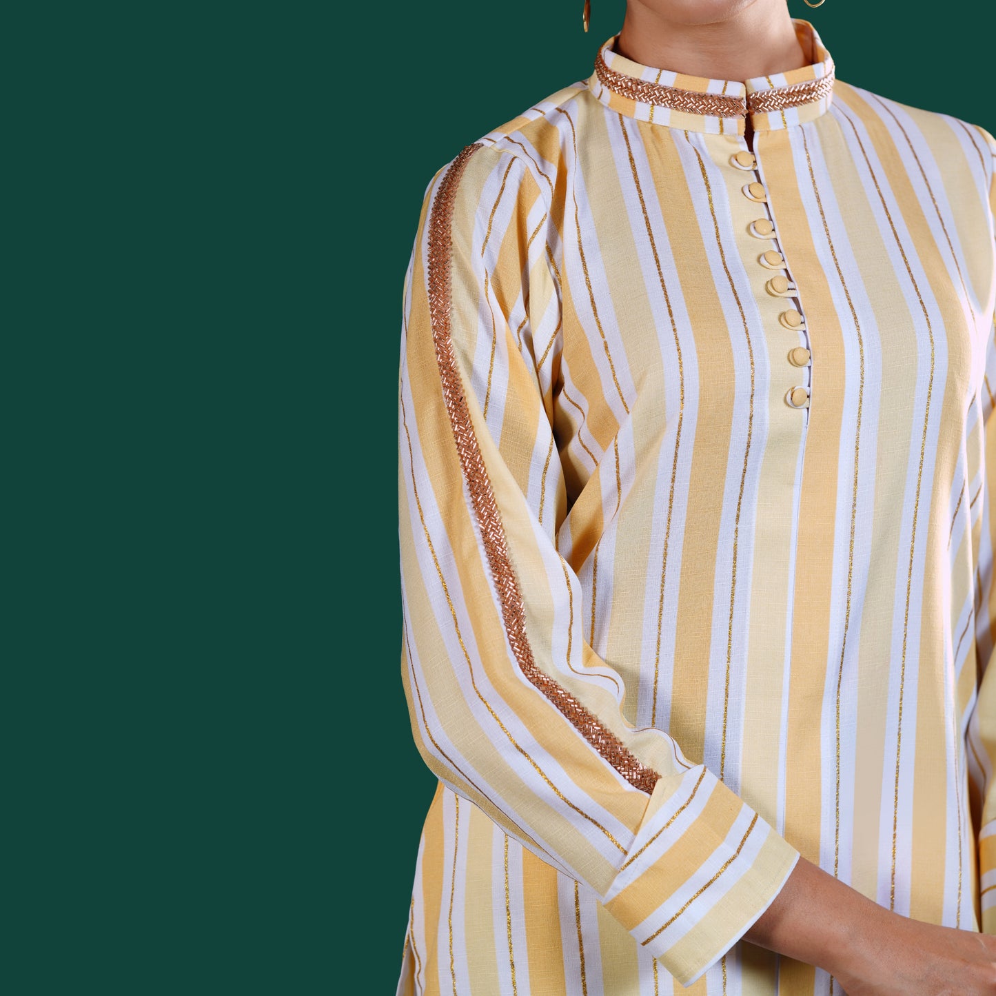 Yellow and white yamaan striped kurti with brown trim on a green background